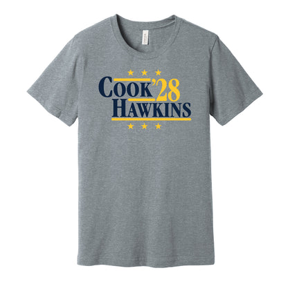 West Virginia Mountaineers retro political campaign parody grey t-shirt featuring Cam Cook and Michael Hawkins Jr. '28, designed in a vintage election style by Hyper Than Hype Shirts.