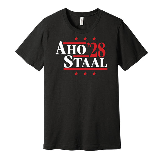 Carolina Hurricanes retro political campaign parody black t-shirt featuring Sebastian Aho and Jordan Staal '28, designed in a vintage election style by Hyper Than Hype Shirts.