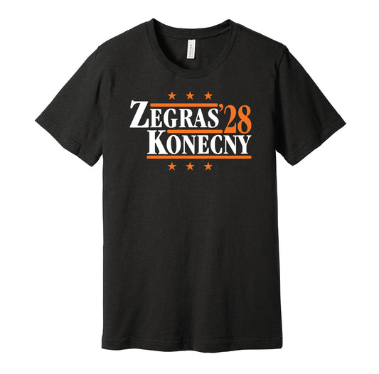 Philadelphia Flyers retro political campaign parody black t-shirt featuring Trevor Zegras and Travis Konecny '28, designed in a vintage election style by Hyper Than Hype Shirts.